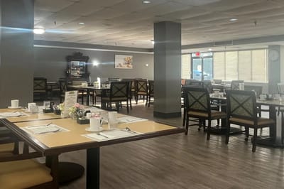 Dining room with set tables and chairs for residents