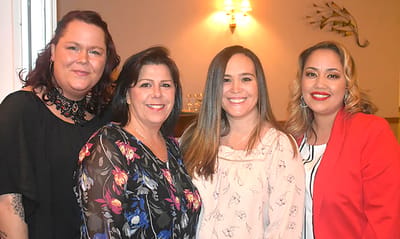 Staff members posing together in an indoor setting