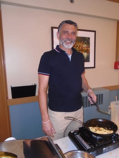 Staff member preparing food in a kitchen