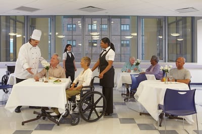 Residents enjoying meals in a dining room setting