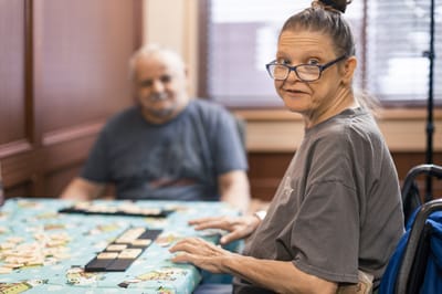 Residents playing dominoes in a common area