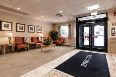 Lobby area with seating and welcome mat