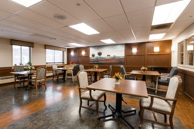 Bright dining room with tables and flowers