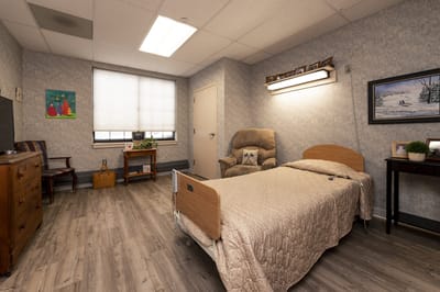 Private resident room with a bed and cozy seating