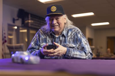 Resident enjoying a game with a model car