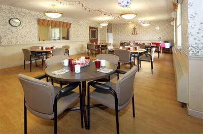 Bright dining room with tables set for meals