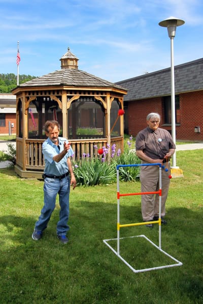 Residents playing outdoor games in a garden area