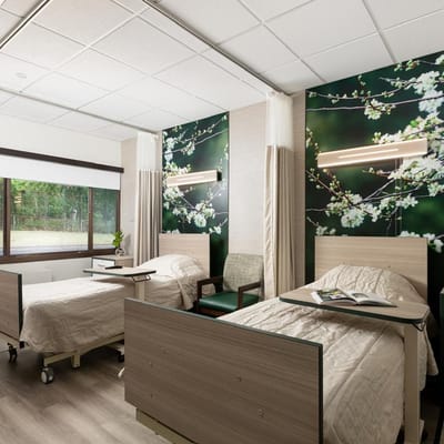 A well-furnished resident room with two beds