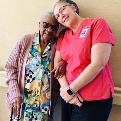 Resident and staff member posing together