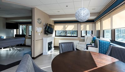 Bright and modern common area with seating and a dining table