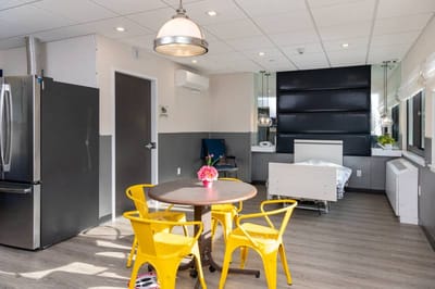 Bright interior of a resident room with a table and chairs