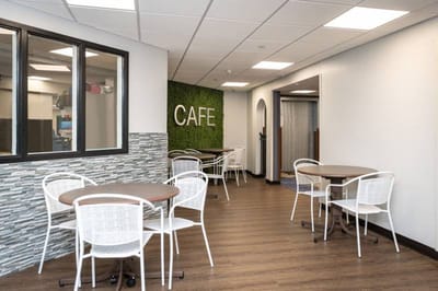 Interior view of a cafe area with tables and chairs