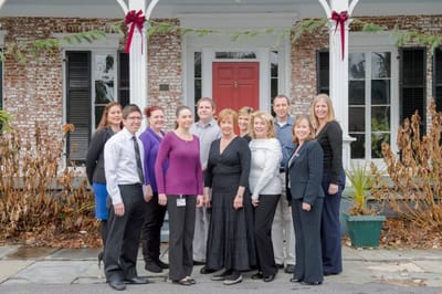 Staff members posing outside the facility entrance