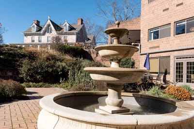 Outdoor courtyard with a fountain and a view of the building