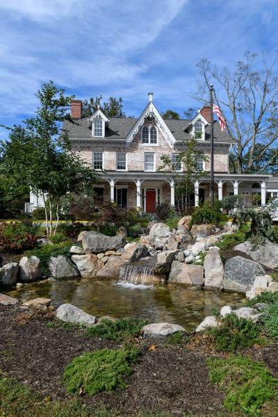 Exterior view of Cortlandt Healthcare with landscaping and pond
