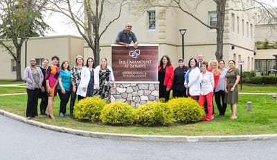 Staff members posing outside the nursing center