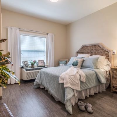 Cozy resident bedroom with a well-made bed and natural light