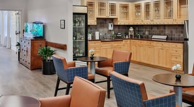 Common area with seating and kitchen area visible