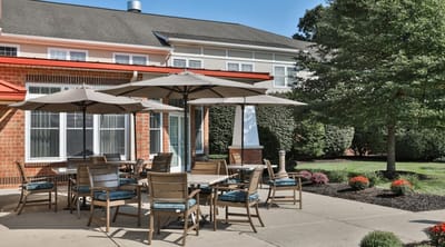 Outdoor seating area with tables and umbrellas