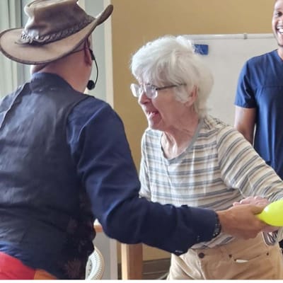 A resident enjoying an activity with staff member