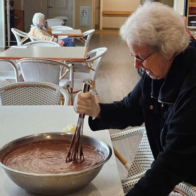 Resident mixing batter in a common area kitchen