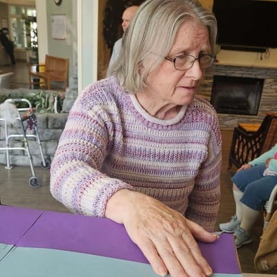 Resident engaged in a craft activity indoors