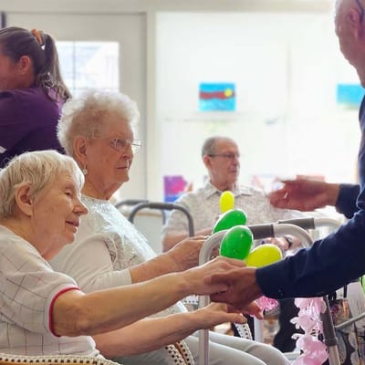 Residents participating in a joyful activity with balloons