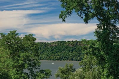 RiverSpring Living, nursing home in Bronx, NY — Scenic river view framed by lush greenery
