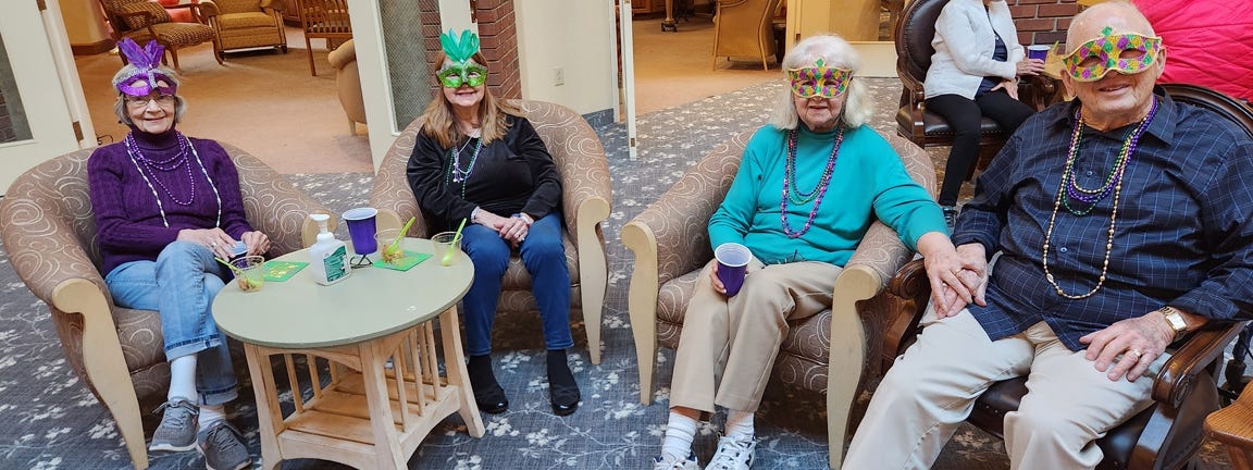 Residents celebrating together in common area with masks