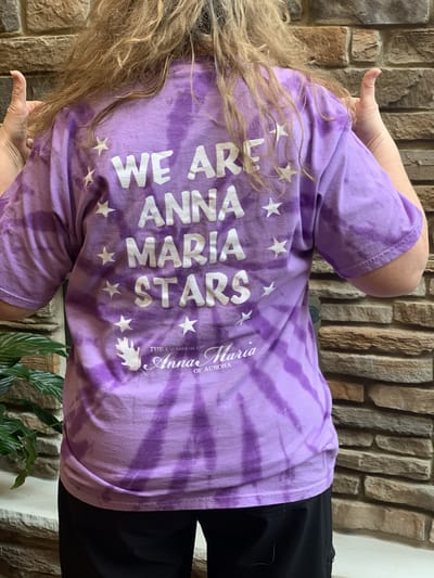 Resident wearing a tie-dye shirt with 'We are Anna Maria Stars'