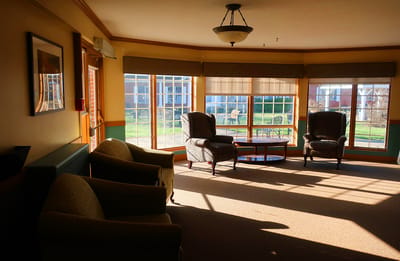 Bright common area with chairs and large windows