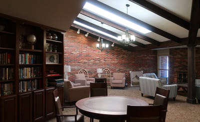 Cozy common area with comfortable seating and bookshelves