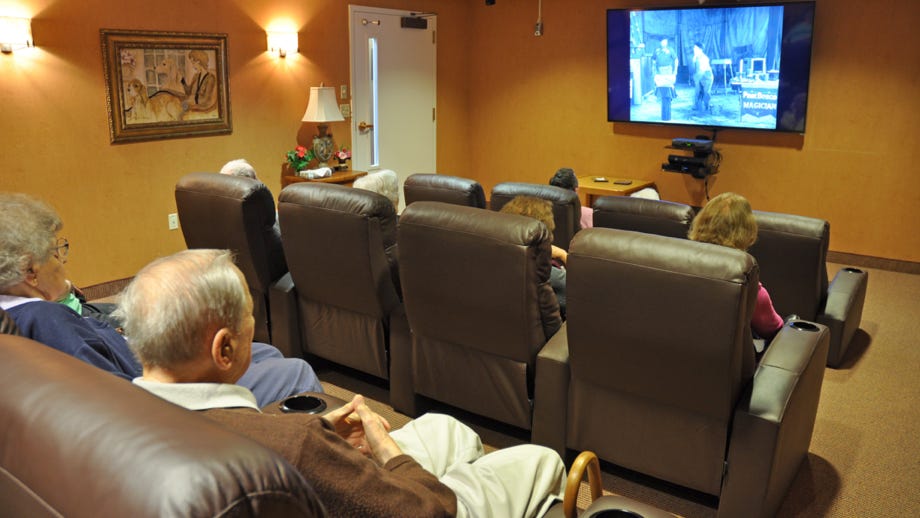 Residents watching a movie in a common area