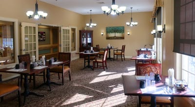 Dining area with tables and chairs ready for residents