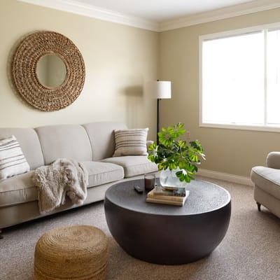 Cozy lounge area with a sofa and decorative mirror