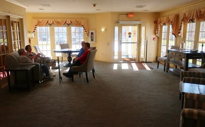 Residents socializing in the common area of the facility