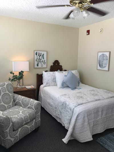 Cozy private resident room with bed and armchair