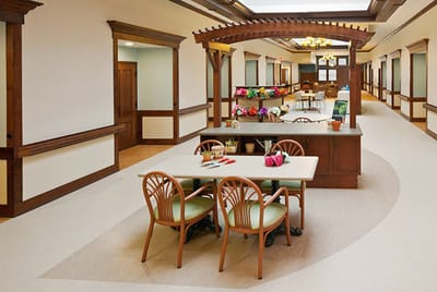 Bright common area with tables and flowers