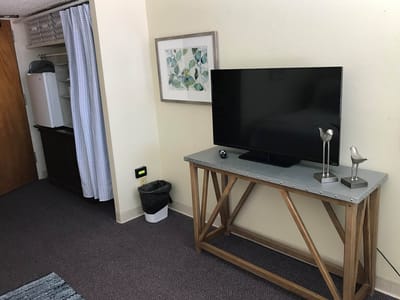 Interior view of a resident room with a TV and decor