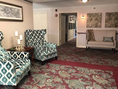 Common area with patterned chairs and carpet