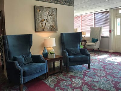 Cozy lounge area with comfortable chairs and decorative artwork