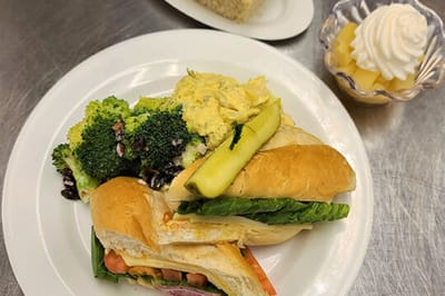 A plate of food with sandwiches and sides