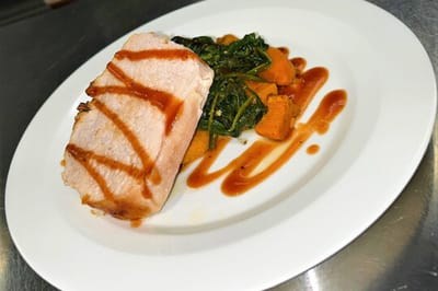 Plated meal featuring pork and vegetables