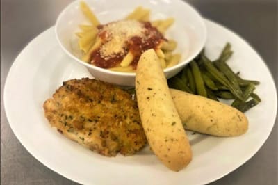 Plated meal with pasta, chicken, and green beans