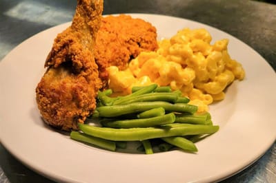 Fried chicken, macaroni, and green beans on a plate