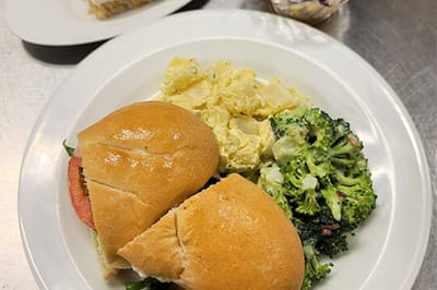 A well-prepared meal featuring sandwiches and broccoli
