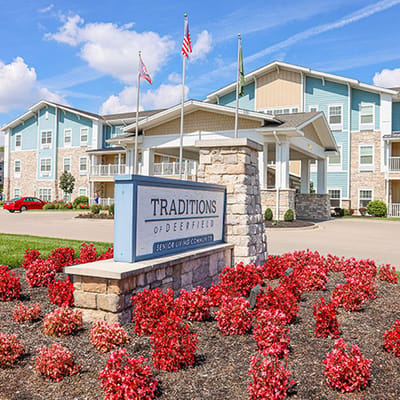 Exterior view of Traditions of Deerfield with colorful flowers