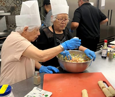 Residents cooking together in a facility kitchen
