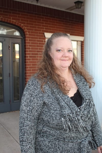 Staff member standing by the building entrance