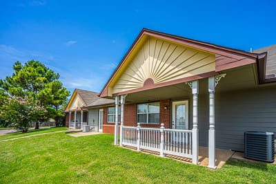 Exterior view of a senior living facility with a porch